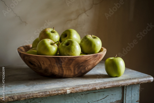 Crisp Green Apples in Rustic Wooden Bowl on Distressed Table. Fresh Fruit for Healthy Eating & Natural Kitchen Decor. Still Life Composition.