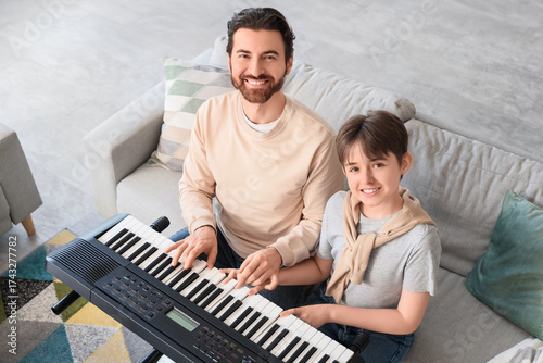 Cute boy taking synthesizer...