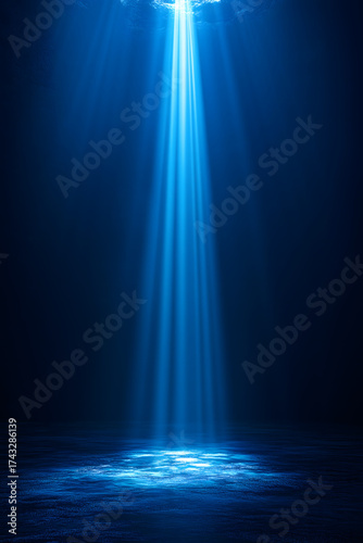 Mystical beams of radiant blue light pierce the darkness over a tranquil ocean surface.