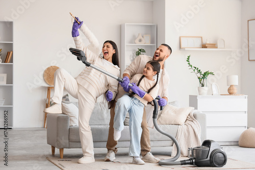 Happy family with vacuum cl...