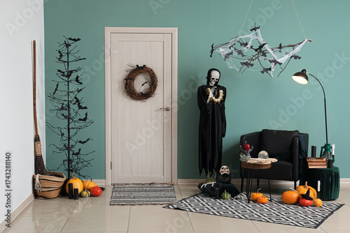 Interior of hallway decorated for Halloween with wreath on door and skeleton