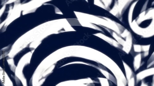 Abstract white brushstrokes swirl on a dark blue background with creating movement.