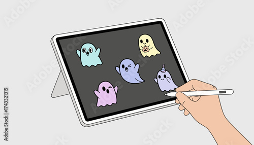 Creative hand draws fun Halloween ghost illustrations on a tablet using a digital pen