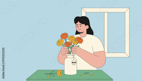 Woman arranging bright orange and yellow flowers in a vase with a skull charm at home