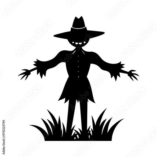 Black silhouette of a scarecrow standing in a field