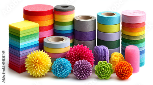 a vibrant collection of rolls and spools of colored material, possibly sandpaper, tape, or paper, stacked and clustered against a white background