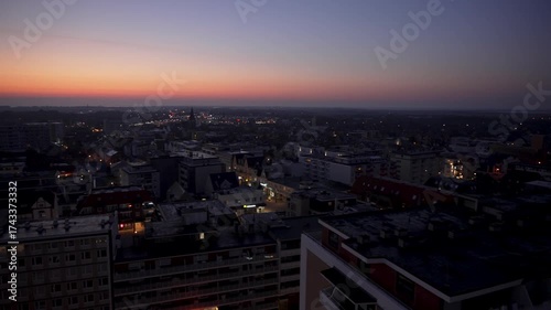 Wallpaper Mural A panoramic camera sweep captures a city at dusk, with glowing lights and a fading sunset on the horizon. The transition from day to night highlights the skyline and atmosphere. Torontodigital.ca