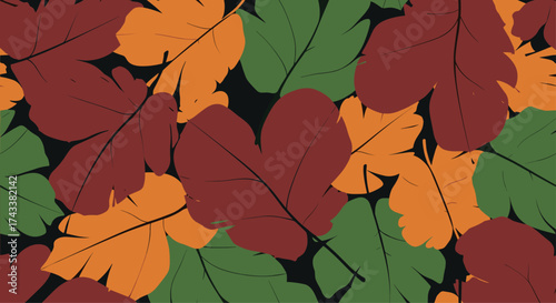 Autumn leaves in warm hues of brown orange and green creating a textured pattern.