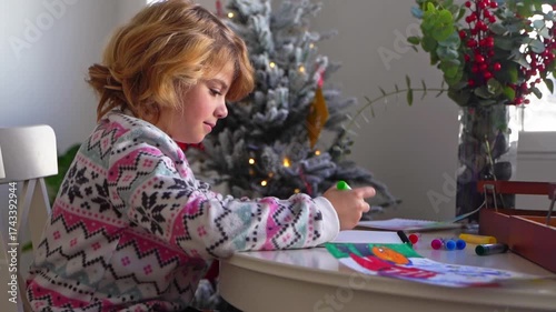 Child writing letter to Santa Christmas New Year holiday, cosy home Christmas decoration and lights, girl dreaming drawing colorful pencils preparing gifts presents for family, boy wishing Santa Claus