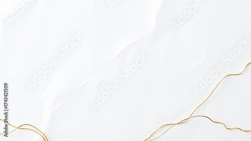 An elegant abstract texture features a clean white paper surface with subtle veining details and delicate, shimme golden threads gracefully winding across it.