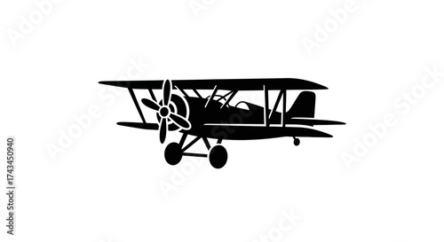 Black silhouette of a biplane isolated on white background in flight