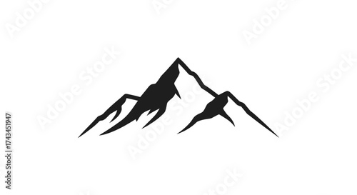 Dramatic silhouette of rugged mountain peaks against a bright sky