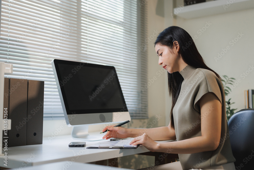 Fototapeta premium Woman working at home office desk checking document