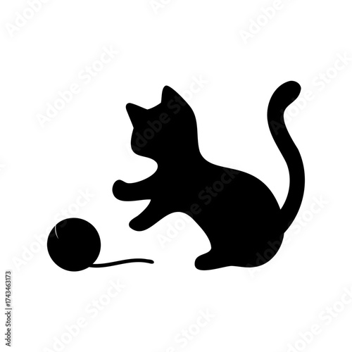 Black silhouette of a playful cat batting at a ball of yarn