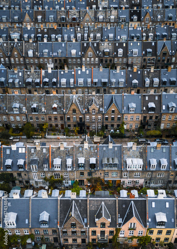 Aerial view of terraced houses displaying a tapestry of grey and beige with rhythmic repetition of gabled roofs, Copenhagen, Denmark.