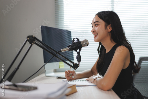 Fotografía Young woman recording a podcast episode at home