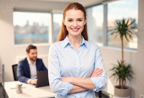 Free Download Businesswoman with arms crossed smiling in bright modern office - GFXLoad