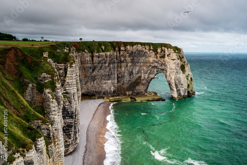 Close view of the Manneporte Cliff, natural rock arch and beach of the alabaster coast, city of Etretat, department of Seine Maritime, Normandie region, France.