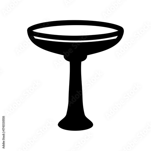 Elegant champagne coupe glass in striking black silhouette against a white backdrop