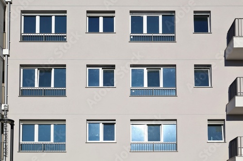 Wallpaper Mural Gray modern residential building facade with PVC windows. Front view, texture. Torontodigital.ca