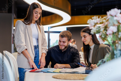 Design team collaborating on fabric swatches for interior project