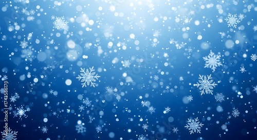 Abstract blue background with falling snowflakes and bokeh lights, representing winter and the holiday season