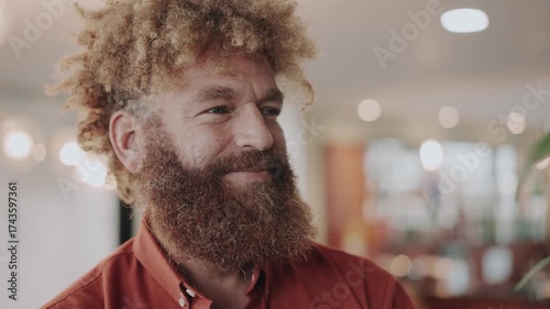 Red-haired businessman gazes away with a subtle smile