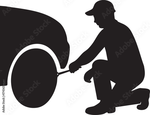 Silhouette of mechanic working on car wheel repair with wrench in garage auto service maintenance automotive assistance