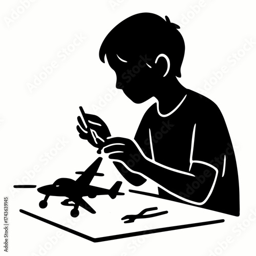 Boy assembling model at desk