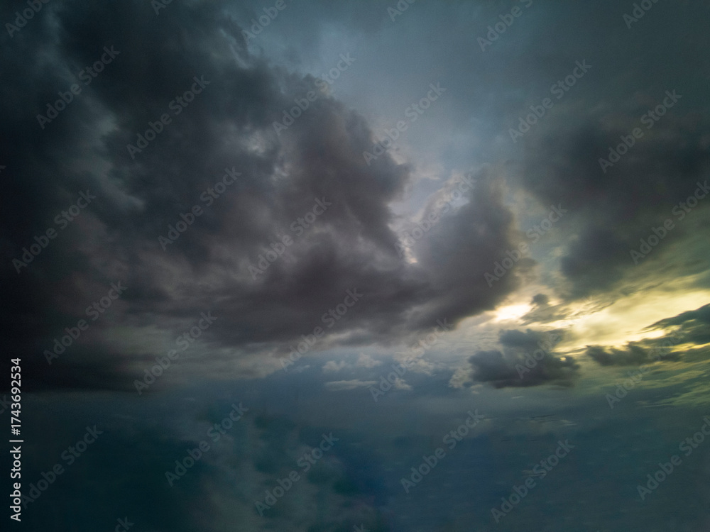 Obraz premium Dramatic dark storm thundercloud rain clouds on black sky background. Dark thunderstorm clouds rainny landscape. Meteorology danger windstorm disaster climate. Dark cloudscape storm disaster gray sky