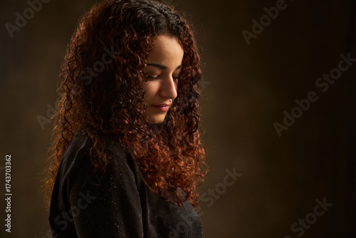 Young woman contemplating with serene expression