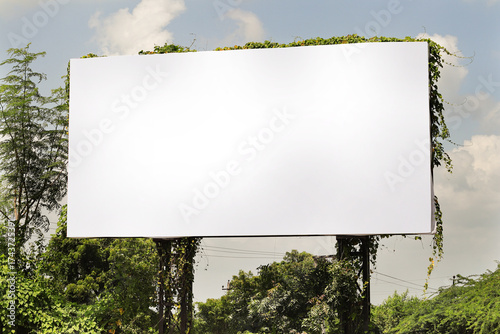 Billboard on rural area of India, outdoor advertising, mockup billing board in front of green tree and Blank white background for branding design large hoarding. Outdoor advertising construction.