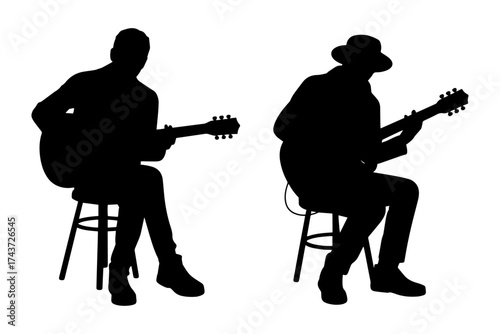 Silhouette of  guitar player playing musical instrument