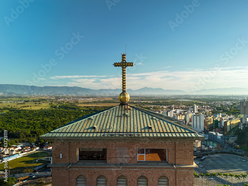 aerial view of a cross at the top of a Catholic church in the countryside of Sao Paulo state in Brazil during sunrise