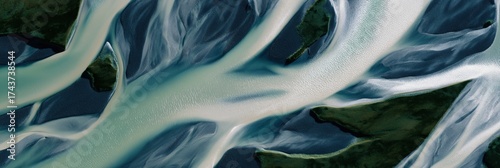 Aerial view of braided river system with dynamic water patterns and lush vegetation