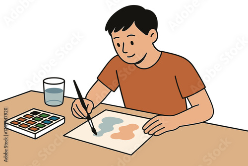 Young artist painting with watercolors at a desk