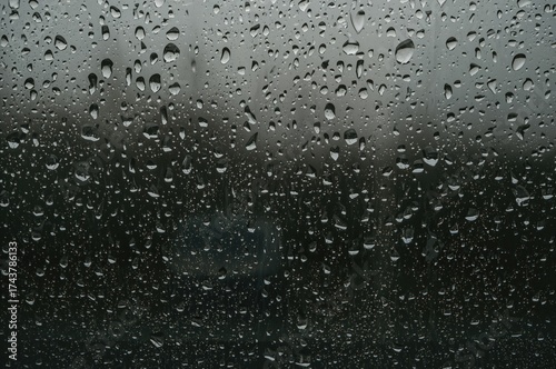 Wallpaper Mural Raindrops on glass create a melancholic mood symbolizing solitude, introspection, and the serene beauty of a rainy day in nature. Torontodigital.ca