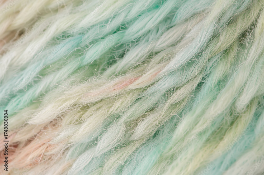 Obraz premium Close-up of vibrant yarn strands on a plain backdrop