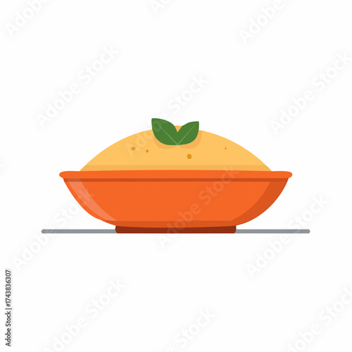 Creamy grits in an orange bowl with fresh mint leaves topping for appetizing breakfast or side dish