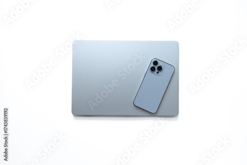Blue silver laptop and phone on white background, top view