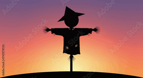 Silhouette of a scarecrow with outstretched arms against a colorful sunset sky.
