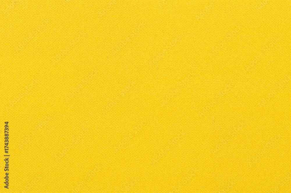 Naklejka premium Bright yellow backdrop with a gentle fabric pattern, ideal for artistic projects or digital applications.