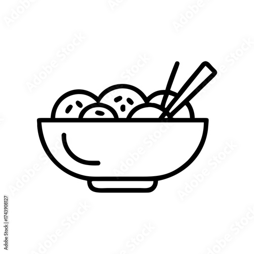 Bowl of pad thai noodles with chopsticks and sesame seeds  
