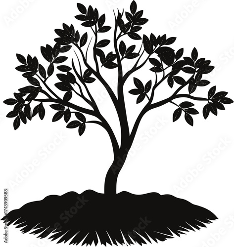 Silhouette of a lush tree growing from a mound of earth