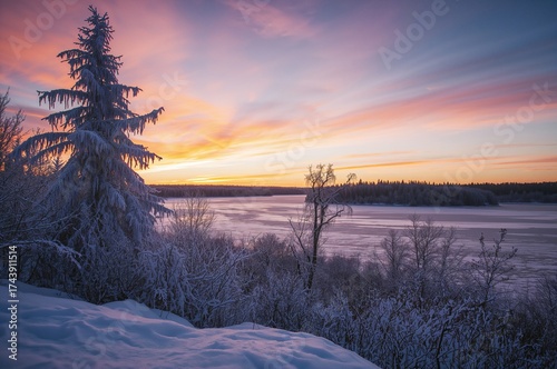 Fototapeta Naklejka Na Ścianę i Meble -  Sunset over a snowy lake in a serene winter forest