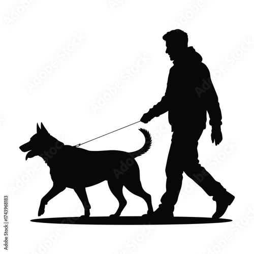 Silhouette of a man walking his dog on a leash during the day