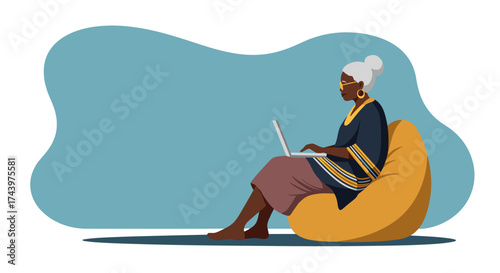 Mature woman using laptop on a bean bag chair highlighting remote work or digital learning