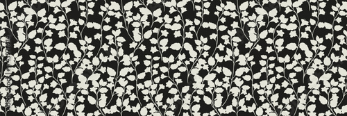 Seamless vector pattern with elegant white floral silhouettes on a black background. Minimal and modern design for fabric, wallpaper, wrapping and stylish decor