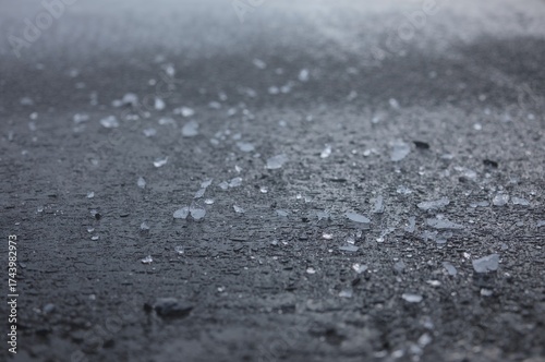 Wet pavement dotted with sp...
