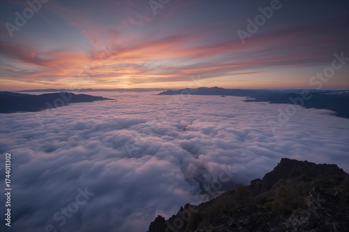 Dawn breaking above a misty...